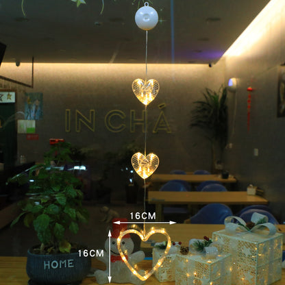 Decorative heart-shaped lights hanging in a room with tables and chairs.