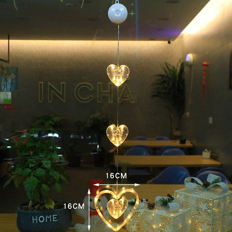 Heart-shaped decorative lights hanging in a room with tables and chairs.
